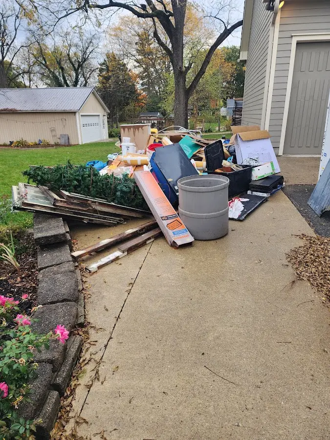 Dumpster being loaded with debris for 30 Yard Dumpster Rental in Malabar